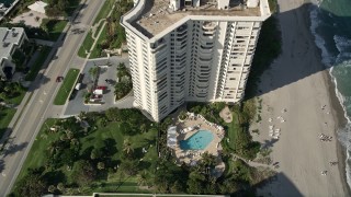 AX0032_023 - 5K aerial stock footage of flying over pool area, coastal condominium complex, Boca Raton, Florida