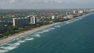AX0032_030 - 5K aerial stock footage of flying by the coast, seen from over the Atlantic, Boca Raton, Florida