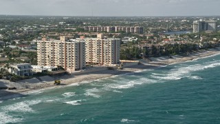 AX0032_032 - 5K aerial stock footage flyby apartment buildings on the beach, Highland Beach, Florida
