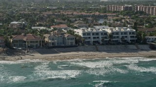 AX0032_034 - 5K aerial stock footage flyby mansions, condominium complex on the beach, Highland Beach, Florida
