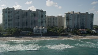 AX0032_036 - 5K aerial stock footage of flying by condominium complexes near the beach, Highland Beach, Florida