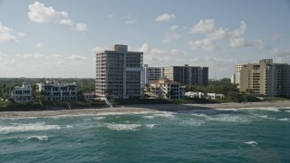 AX0032_037 - 5K aerial stock footage flyby an apartment building by the beach, Highland Beach, Florida