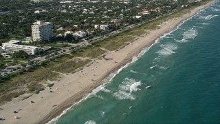 AX0032_045 - 5K aerial stock footage of flying by sunbathers on the beach, Delray Beach, Florida