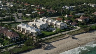 AX0032_050 - 5K aerial stock footage of flying by a condominium complex by the shore, Ocean Ridge, Florida