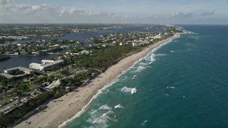 AX0032_052E - 5K aerial stock footage of following the coast near Boynton Beach Park to approach condos, Boynton Beach, Florida