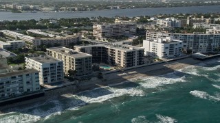 AX0032_061 - 5K aerial stock footage of apartment building on the coast, Palm Beach, Florida