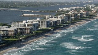 AX0032_063 - 5K aerial stock footage of flying by coastal condominium complexes, Palm Beach, Florida