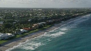 AX0032_124 - 5K aerial stock footage of panning across homes by the beach on the coast, North Palm Beach, Florida