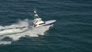 AX0032_140E - 5K aerial stock footage of tracking a fishing boat on the Atlantic Ocean, Jupiter, Florida