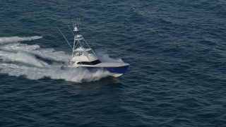AX0032_144 - 5K aerial stock footage of tracking a fishing boat racing across the Atlantic, Jupiter, Florida