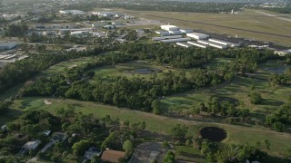 AX0032_162 - 5K aerial stock footage of flying by Martin County Golf and Country Club, tilt down on pond, Stuart, Florida