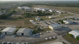 AX0032_163 - 5K aerial stock footage of flying over Witham Field Airport, revealing jets on tarmac, Stuart, Florida