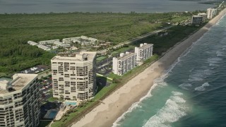 AX0033_014 - 5K aerial stock footage of fly by beachside apartment buildings, Jensen Beach, Florida