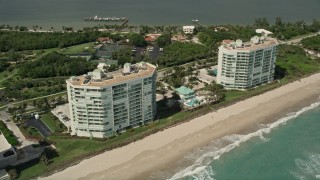 AX0033_015 - 5K aerial stock footage of a beachside condominium complex, Jensen Beach, Florida