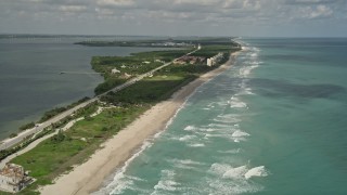 AX0033_016E - 5K aerial stock footage of following the beach along the coast, Jensen Beach, Florida