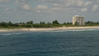AX0033_044 - 5K aerial stock footage of flying by sunbathers on the beach, Fort Pierce, Florida