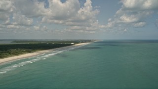 AX0033_050 - 5K aerial stock footage of approaching coastal beach and blue waters, Vero Beach, Florida