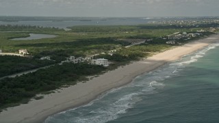 AX0033_051 - 5K aerial stock footage of approaching a condominium complex by the beach, Vero Beach, Florida