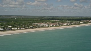 AX0033_064 - 5K aerial stock footage of flying by a beach side condominium complex, Vero Beach, Florida