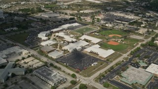 AX0033_078E - 5K aerial stock footage video of approaching a high school and sports fields, Melbourne, Florida