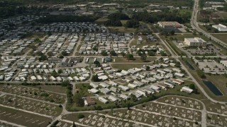 AX0033_080 - 5K aerial stock footage of orbiting a mobile home park, Melbourne, Florida