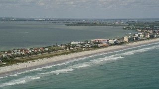 AX0034_007 - 5K aerial stock footage fly along beach of Cocoa Beach, Florida