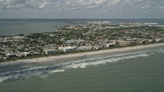 AX0034_012 - 5K aerial stock footage fly by a beach with hotels and condominiums, Cocoa Beach, Florida