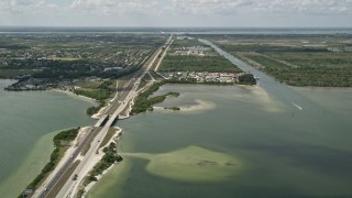 AX0034_023 - 5K aerial stock footage of following the Bennett Causeway toward Merritt Island, Florida
