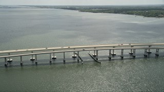 AX0034_025 - 5K aerial stock footage of orbiting a causeway, Merritt Island, Florida