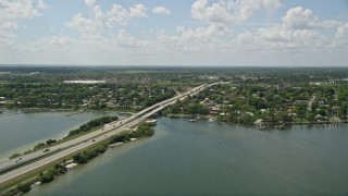 AX0034_026E - 5K aerial stock footage of panning across a causeway revealing residential neighborhoods, Cocoa, Florida