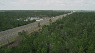 AX0034_059E - 5K aerial stock footage fly low over forest, Cocoa, Florida