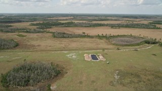 AX0034_067E - 5K aerial stock footage of flying over marshland, Wedgefield, Florida