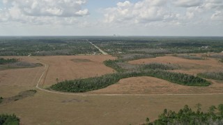 AX0034_069 - 5K aerial stock footage video fly over marshland toward town, Wedgefield, Florida