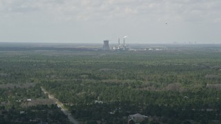 AX0034_072 - 5K aerial stock footage fly over trees toward a coal fired power generation facility, Orlando, Florida
