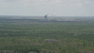 AX0034_073 - 5K aerial stock footage of approaching a coal fired power generation facility, Orlando, Florida