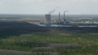 AX0034_074 - 5K aerial stock footage of approaching a coal fired power generation facility, Orlando, Florida