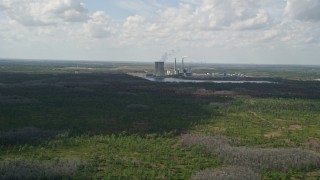 AX0034_075 - 5K aerial stock footage of approaching a coal fired power generation facility, Orlando, Florida