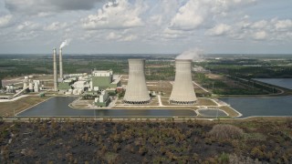 AX0034_080 - 5K aerial stock footage of flying by a coal fired power generation facility, Orlando, Florida