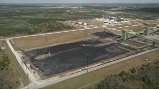 AX0034_081 - 5K aerial stock footage of approaching part of a coal fired power generation facility, Orlando, Florida