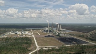 AX0034_082 - 5K aerial stock footage fly away from a coal fired power generation facility, Orlando, Florida