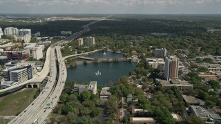 AX0034_090E - 5K aerial stock footage of Lake Lucerne next to the Expressway, Downtown Orlando. Florida