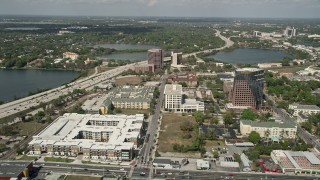 AX0034_096 - 5K aerial stock footage of apartment and office buildings along North Orange Avenue, Downtown Orlando, Florida