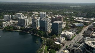 AX0034_101E - 5K aerial stock footage of approaching condominium complex and office buildings, Downtown Orlando, Florida