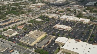 AX0034_114 - 5K aerial stock footage of approaching a shopping mall and parking lot, Orlando, Florida