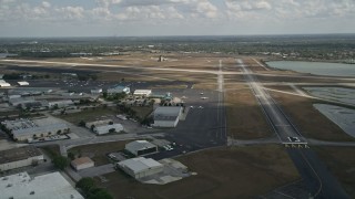 AX0034_115 - 5K aerial stock footage of flying by Orlando Executive Airport, Florida