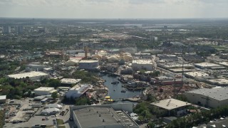 AX0035_014E - 5K aerial stock footage of flying by Universal Studios Florida theme park, Orlando, Florida
