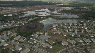 AX0035_085 - 5K aerial stock footage flyby residential neighborhood and wetlands, Clermont, Florida