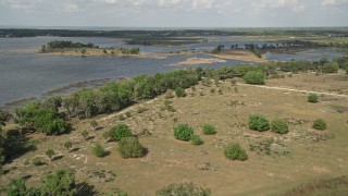 AX0035_101E - 5K aerial stock footage fly over Johns Lake toward trees on the shore, Florida