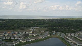 AX0035_105 - 5K aerial stock footage fly over waterfront homes to approach a lake in Winter Garden, Florida