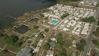 AX0035_111 - 5K aerial stock footage approach mobile home park on the shore of a lake, Winter Garden, Florida